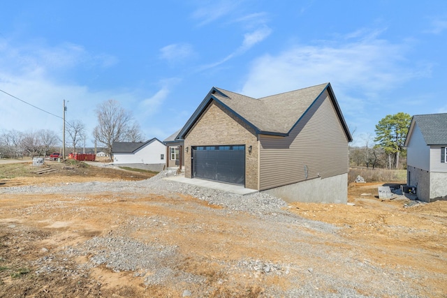 view of property exterior featuring driveway and an attached garage