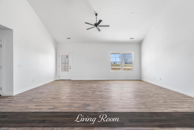 unfurnished living room with wood finished floors, a ceiling fan, and baseboards