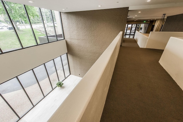 hallway featuring brick wall