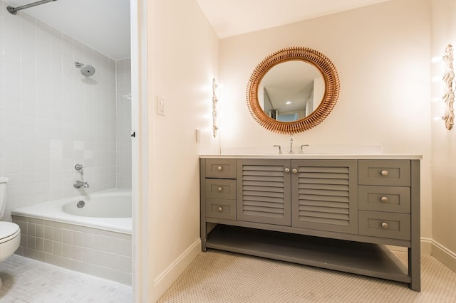 full bathroom featuring tile patterned floors, tiled shower / bath combo, toilet, and vanity