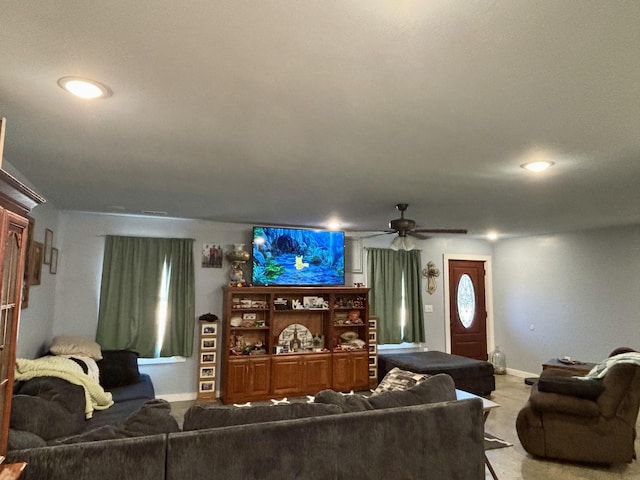 carpeted living room featuring ceiling fan