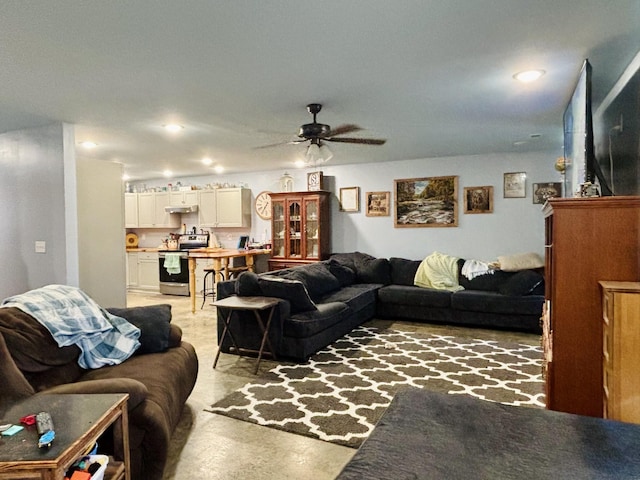 living room featuring ceiling fan and concrete flooring