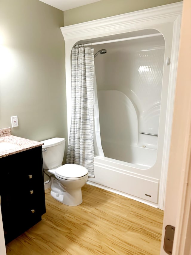 full bathroom featuring vanity, toilet, wood-type flooring, and shower / tub combo with curtain