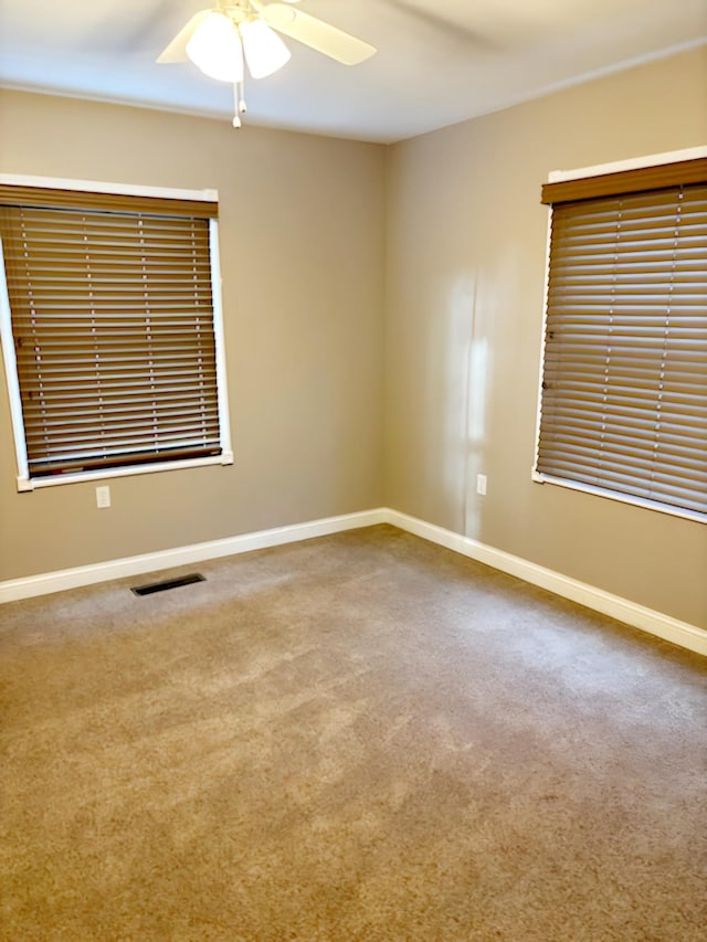 spare room with carpet flooring and ceiling fan