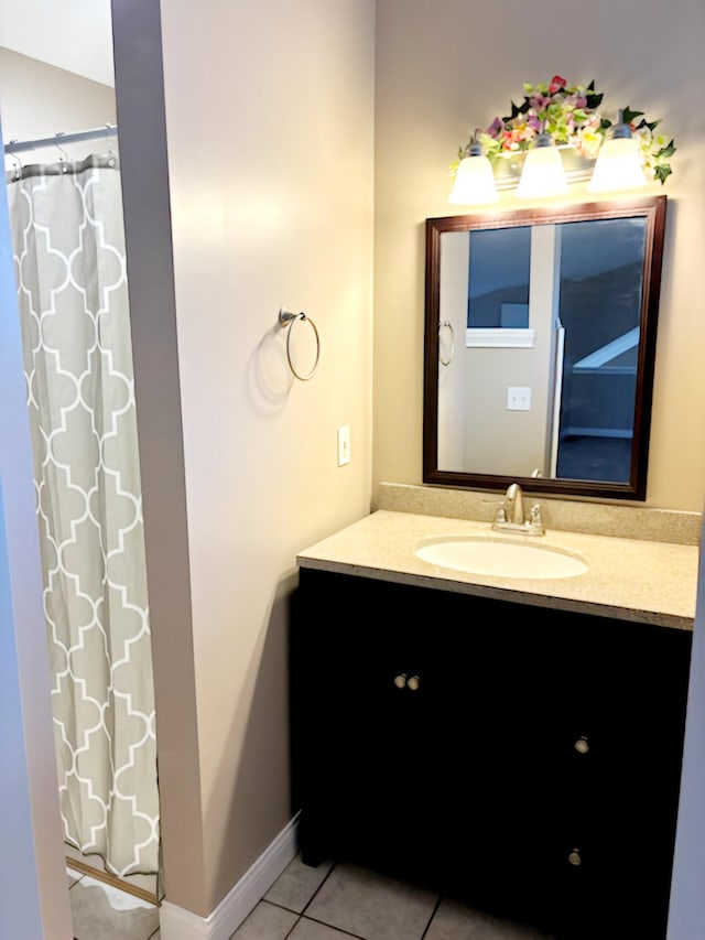 bathroom with a shower with curtain, vanity, and tile patterned floors