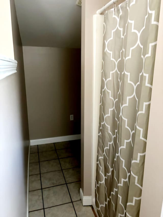 corridor featuring tile patterned flooring