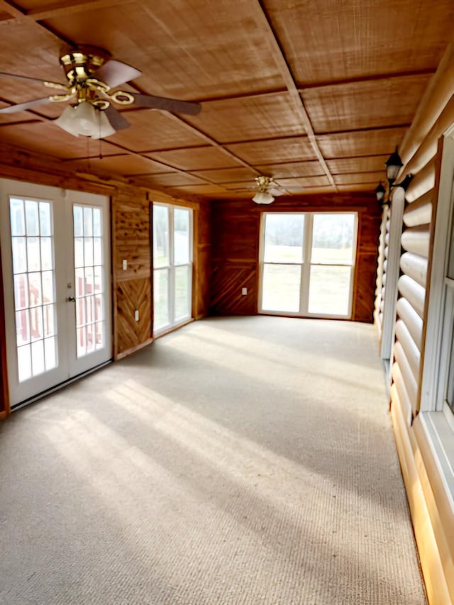 spare room with french doors, wooden walls, carpet flooring, ceiling fan, and wood ceiling