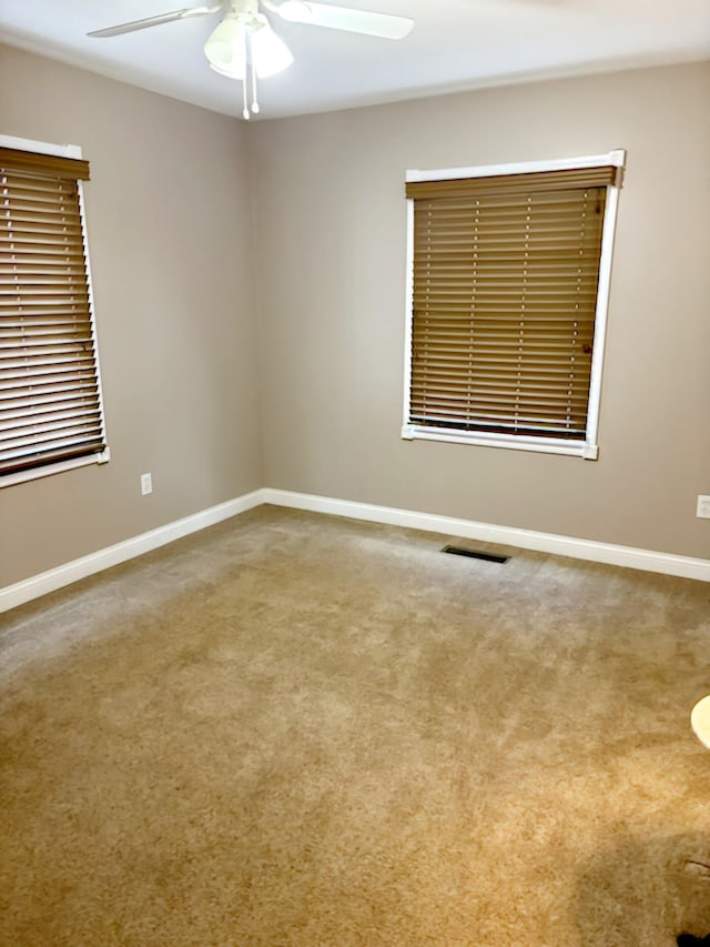 unfurnished room with carpet and ceiling fan