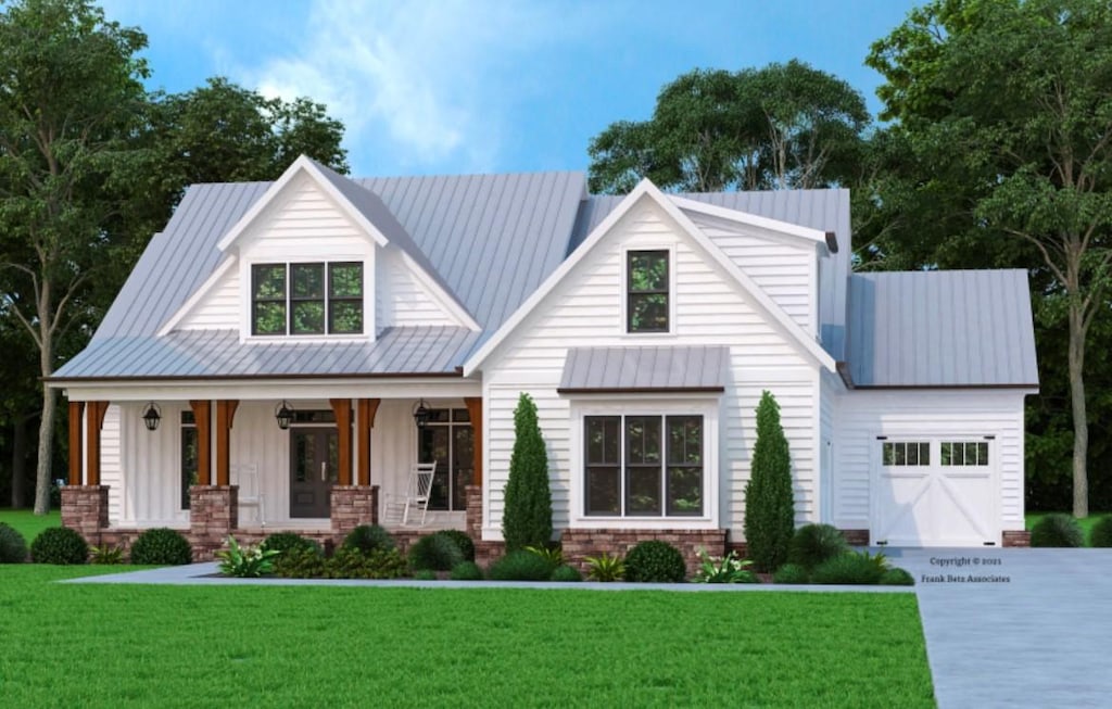 view of front facade featuring a front lawn, covered porch, and a garage