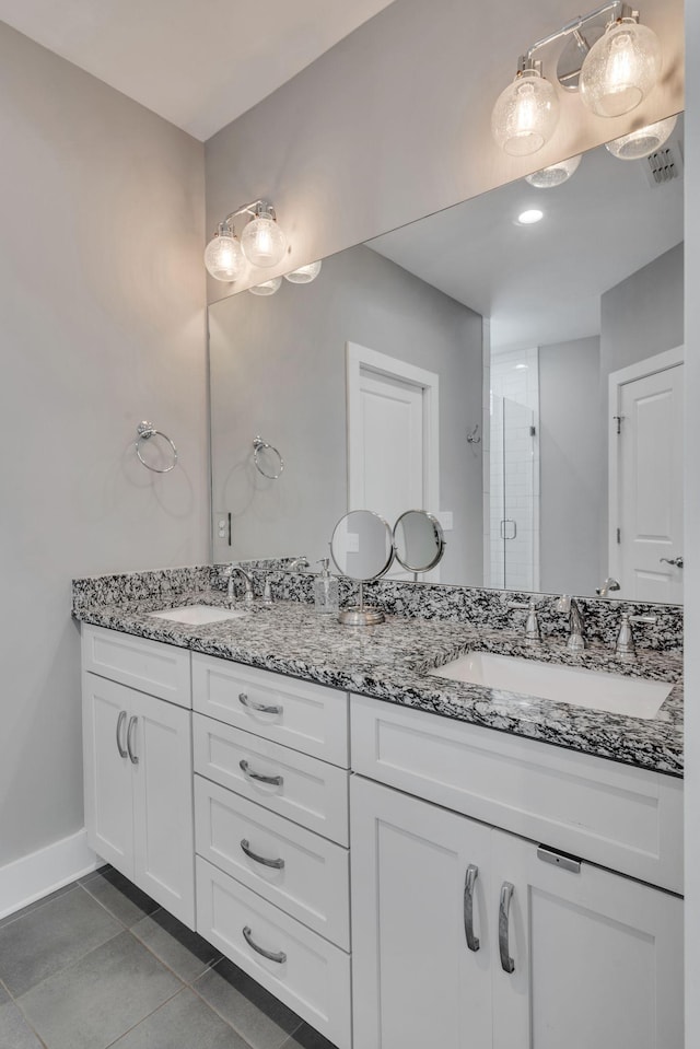 bathroom featuring tile patterned floors, vanity, and walk in shower