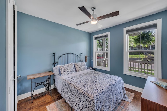 bedroom featuring ceiling fan and dark wood-type flooring