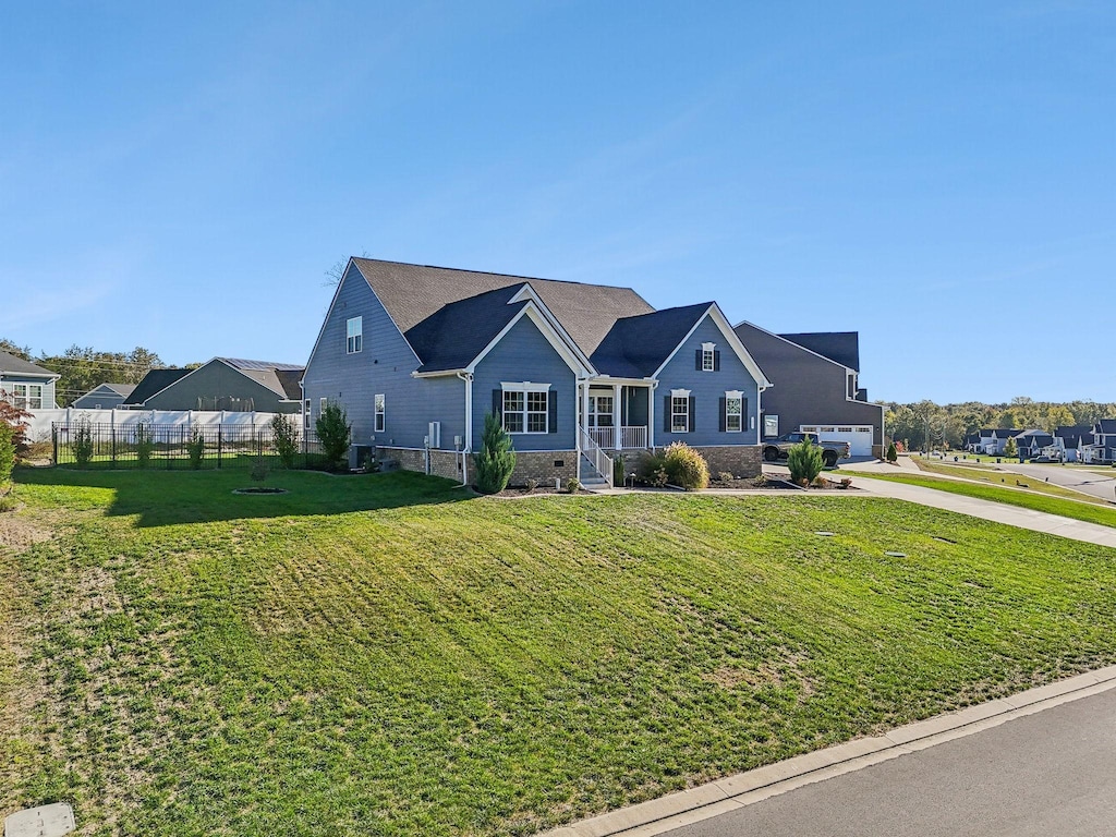 view of front of property featuring a garage and a front lawn