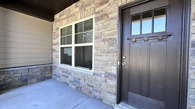 view of exterior entry with a porch