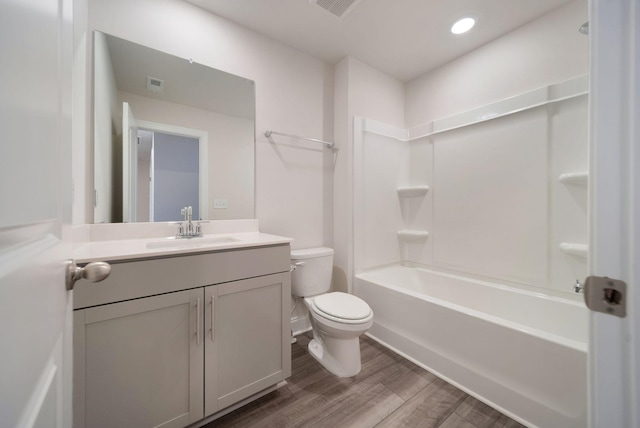 full bathroom with vanity, toilet, wood-type flooring, and bathing tub / shower combination