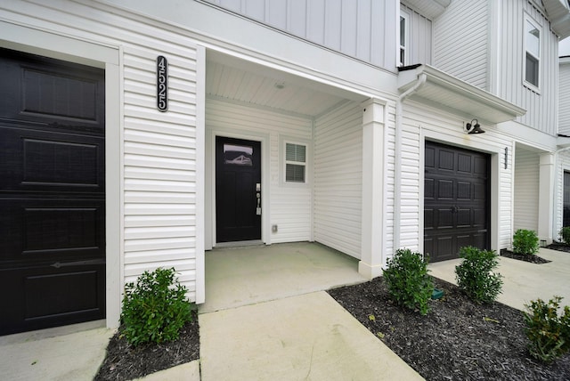 property entrance with a porch and a garage