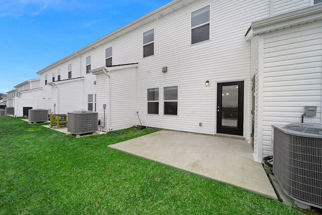 back of house featuring a lawn, a patio area, and cooling unit