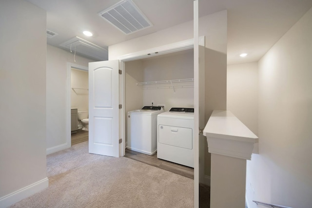 laundry area featuring washer and dryer and light colored carpet