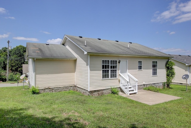 rear view of property featuring a yard and a patio area