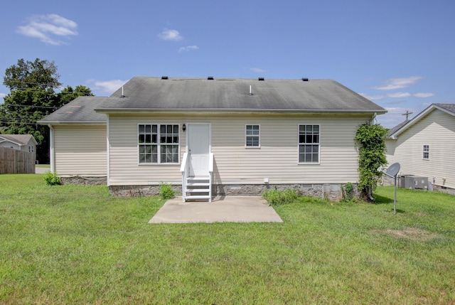 rear view of house featuring a lawn and a patio