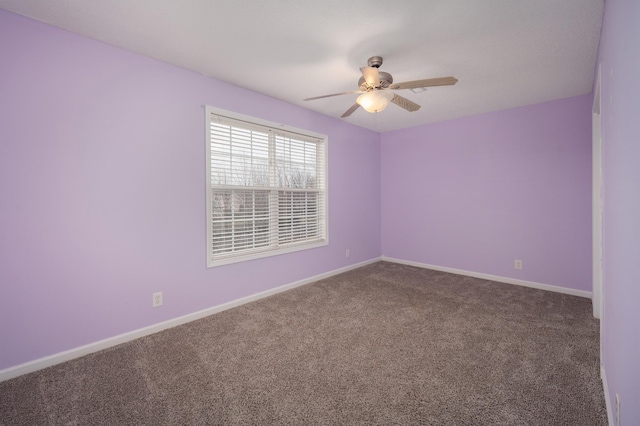 carpeted empty room featuring ceiling fan