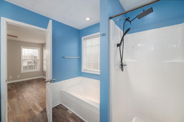 bathroom featuring wood-type flooring, a textured ceiling, and plenty of natural light