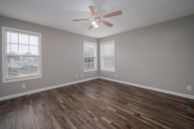 empty room with dark hardwood / wood-style flooring and ceiling fan