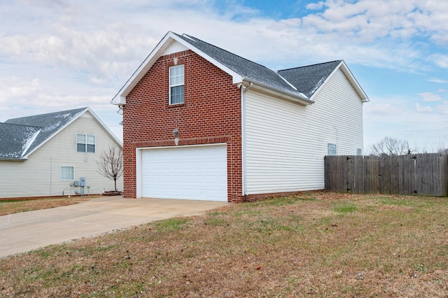 view of side of property with a lawn and a garage