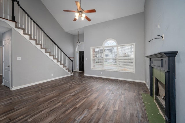 unfurnished living room featuring ceiling fan, high vaulted ceiling, and dark wood-type flooring