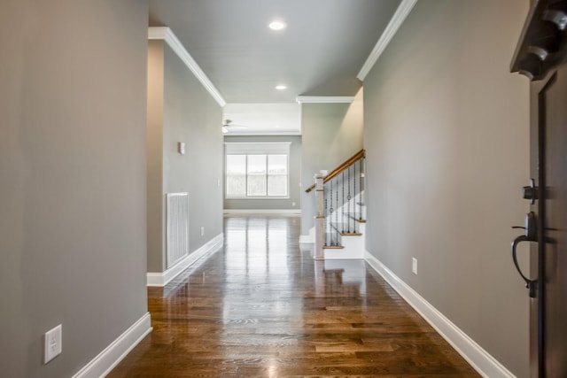 entrance foyer with ornamental molding and dark hardwood / wood-style flooring