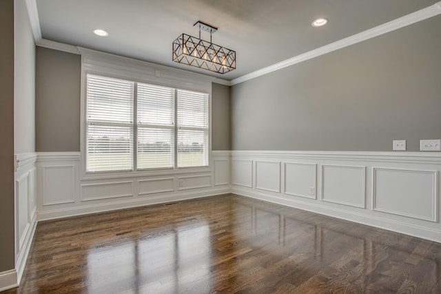 empty room with crown molding and dark wood-type flooring