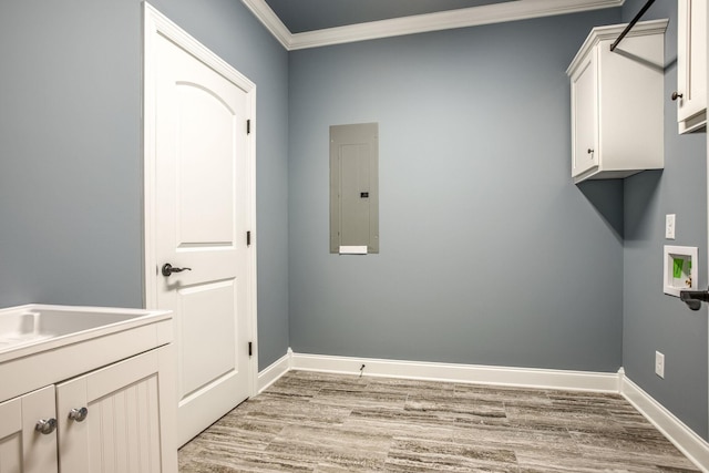 laundry area with cabinets, light hardwood / wood-style flooring, ornamental molding, electric panel, and washer hookup