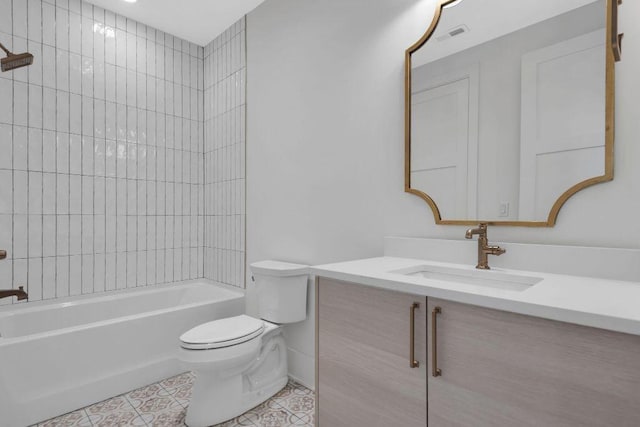 full bathroom featuring tile patterned floors, tiled shower / bath combo, toilet, and vanity