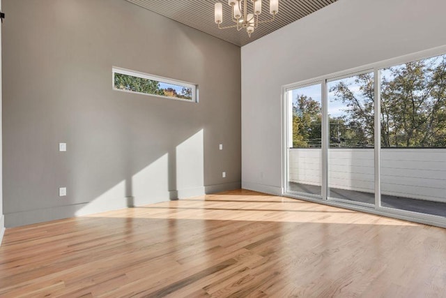 unfurnished living room featuring light hardwood / wood-style floors and a notable chandelier