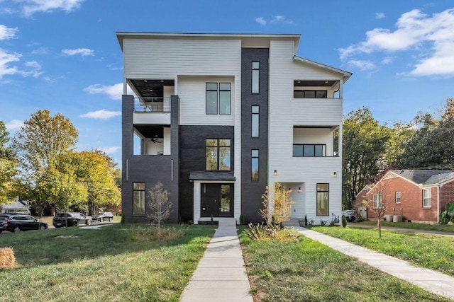 contemporary house featuring a front lawn