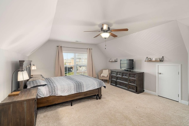 bedroom with vaulted ceiling, light carpet, and ceiling fan