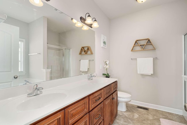 bathroom featuring tile patterned flooring, vanity, an enclosed shower, and toilet