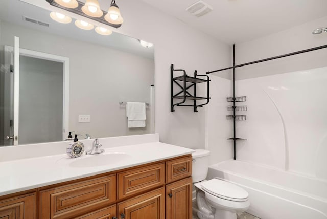 full bathroom featuring washtub / shower combination, vanity, and toilet