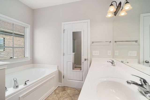 bathroom featuring tile patterned flooring, vanity, and a bath