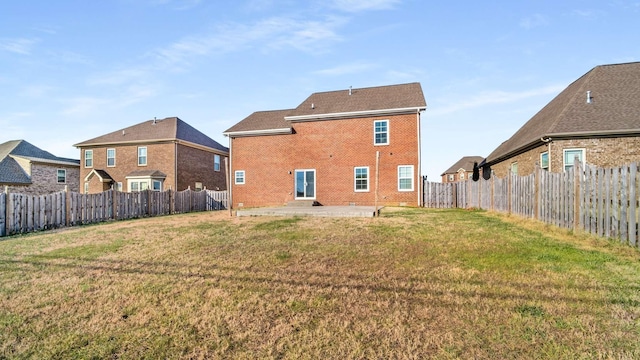 back of property with a patio and a lawn