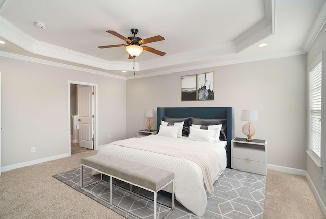 bedroom featuring ceiling fan, a raised ceiling, and light colored carpet