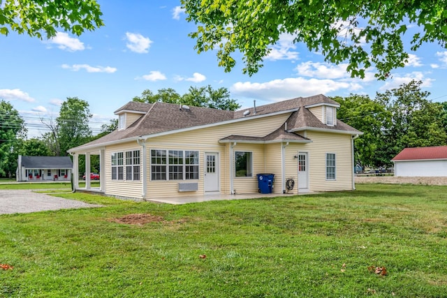 back of house with a lawn