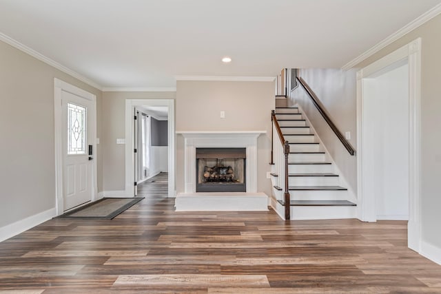 foyer with dark hardwood / wood-style flooring and ornamental molding