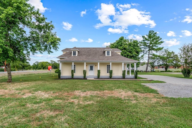 view of front of property with covered porch and a front yard