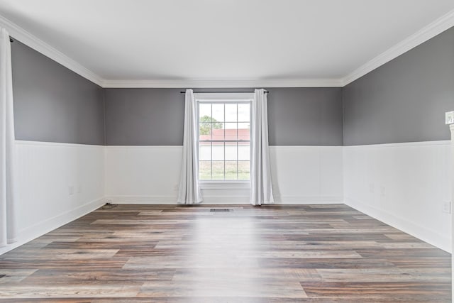 spare room with wood-type flooring and ornamental molding