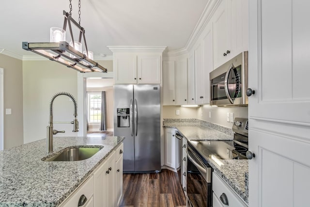 kitchen featuring white cabinetry, sink, hanging light fixtures, crown molding, and appliances with stainless steel finishes