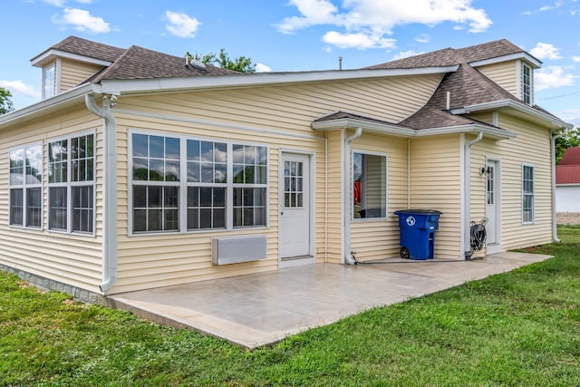 back of property with a yard and a patio