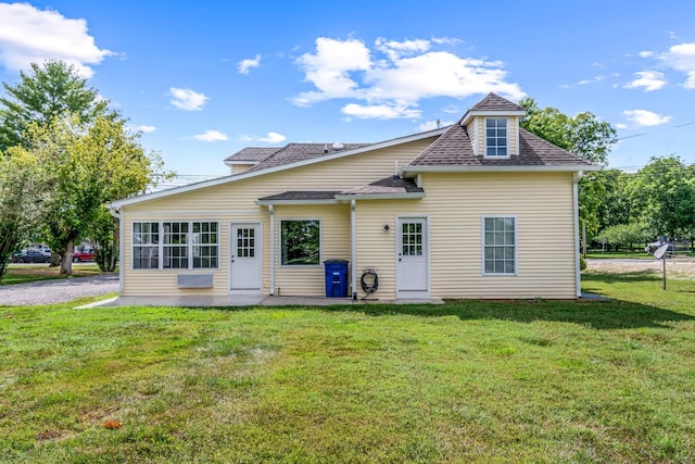 back of property featuring a yard and a patio