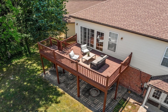 wooden deck featuring an outdoor living space, a patio area, and a yard