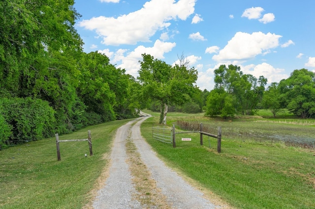 surrounding community featuring a yard and a rural view