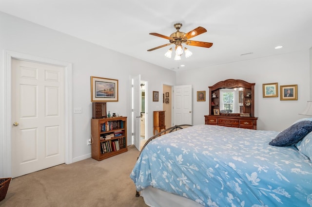 carpeted bedroom featuring ceiling fan and ensuite bathroom